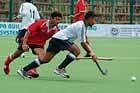 HAL and COE team players battle for the possession of the ball in the State-level Super Division Hockey League Championship in Madikeri on Tuesday. DH Photo