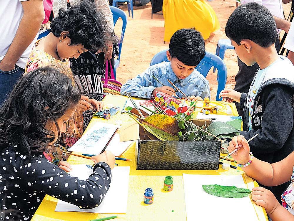 Children participate in a drawing competition at the Bellandur Kere Habba held on Saturday. DH&#8200;photo