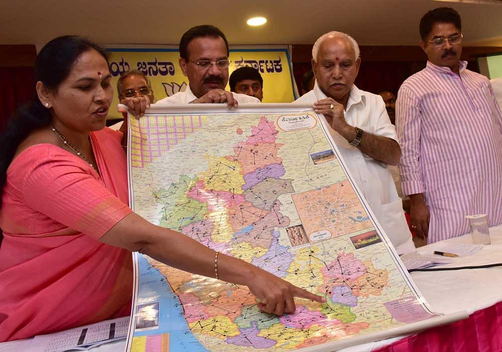 BJP state general secretary Shobha Kharandlaje explains the route map of the party's proposed Nava Karnataka Parivarthana Yatra in Bengaluru on Monday. BJP leaders  D V Sadananda Gowda, B S Yeddyurappa are seen. DH Photo