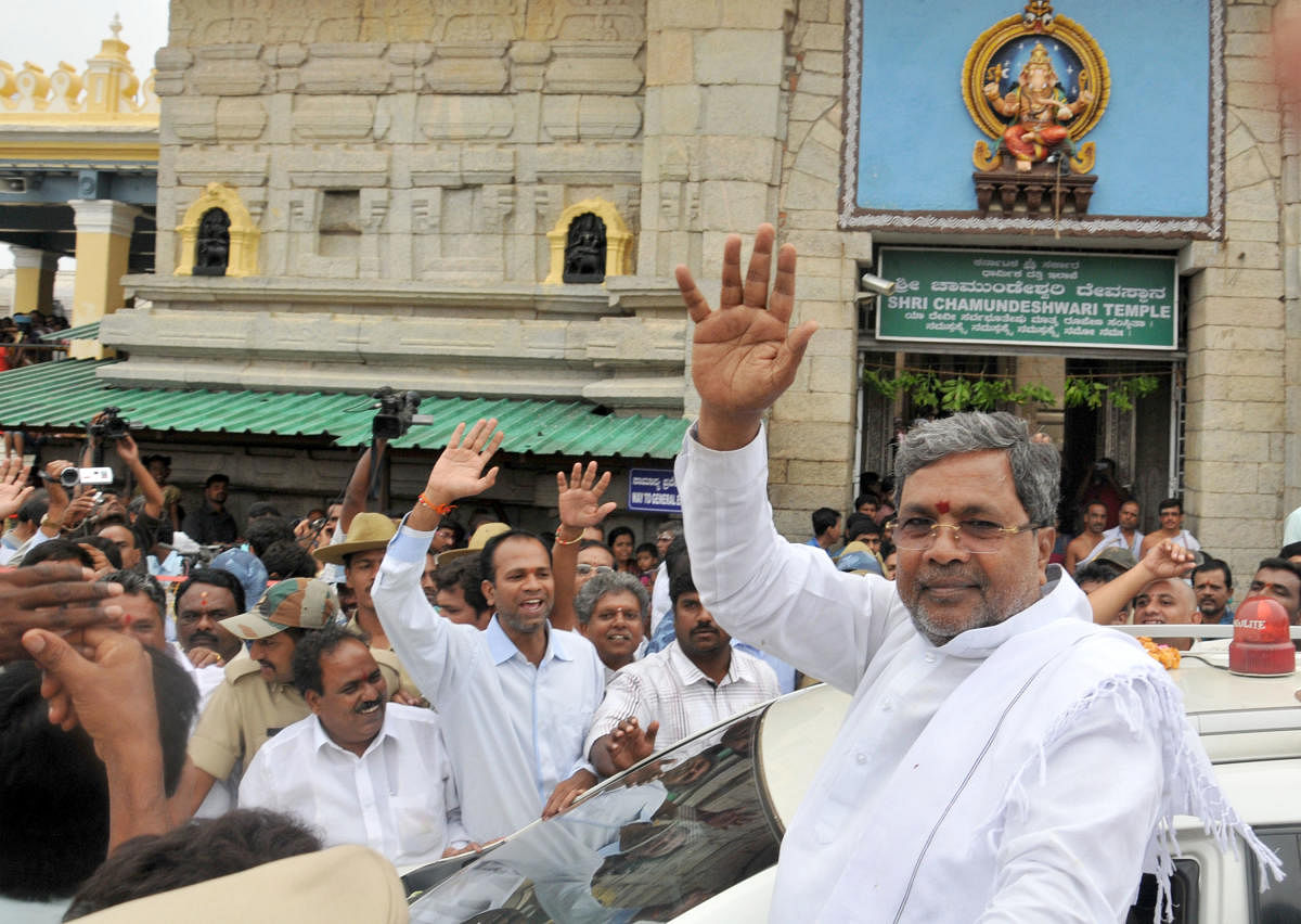 Designated Chief Minister Siddaramaiah waves to the crowd during his visit to Chamundi Hill and took the blessings of goddess Chamundeshwari in Mysore on Sunday.Siddaramaiah