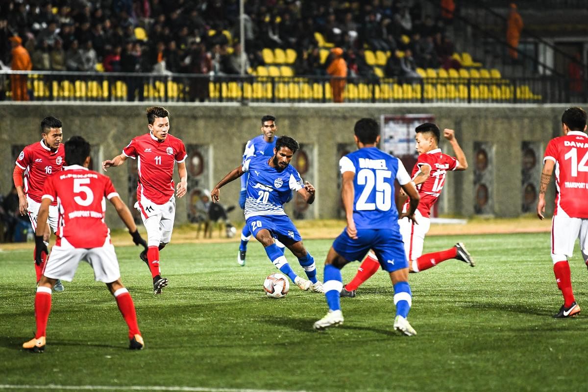 STUCK IN TRAFFIC! Bengaluru FC's Alwyn George (middle) tries to make his way past Transport United players at the Changlimithang Stadium on Tuesday. BFC MEDIA