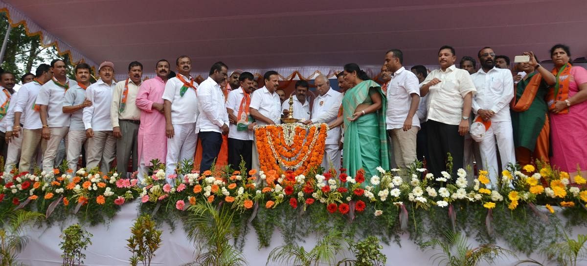 Former Chief Minister and BJP State President B S Yeddyurappa lighting a lamp to inaugurate Parivarthana rally in Madikeri on Wednesday. Union Minister DVSadananda Gowda and MPShobha Karandlaje among others look on.