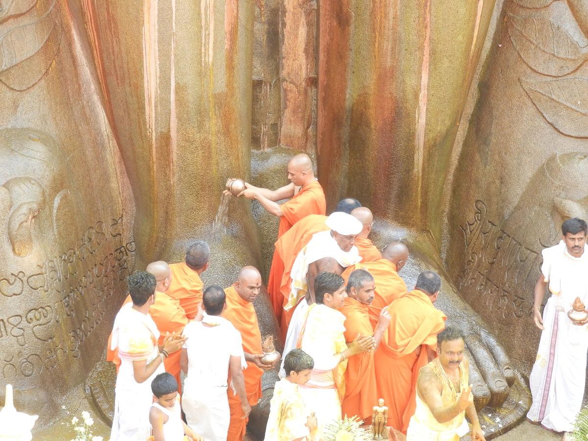 Adichunchanagiri seer Nirmalanandanatha Swami performs jalabhisheka to the feet of Bahubali, atop Vindhyagiri in Shravanabelagola on Wednesday.