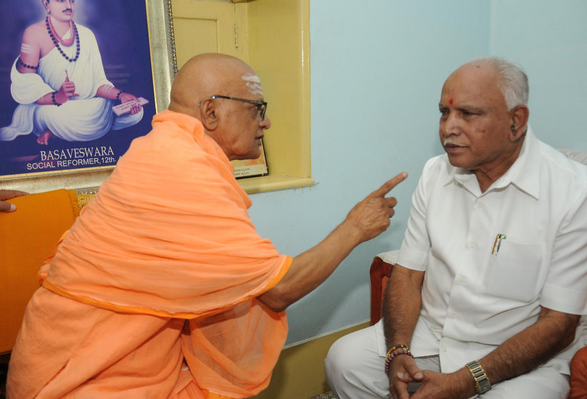 State BJP president B S Yeddyurappa has a word with Hosamutt seer Chidananda Swami, in Mysuru on Tuesday. DH PHOTO