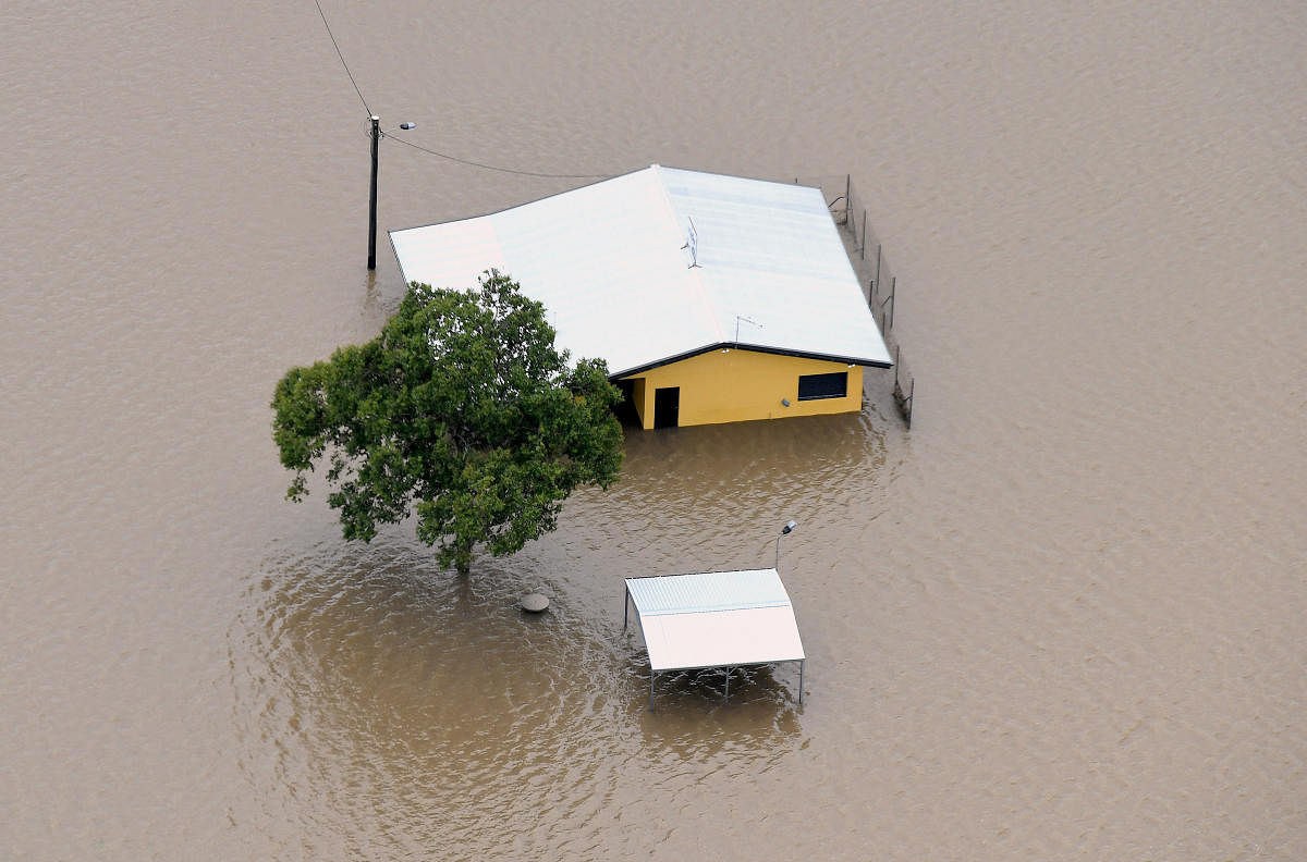 A house is surrounded by flood waters in the town of Ingham, located in North Queensland, Australia, March 11, 2018. AAP/Dan Peled/via REUTERS