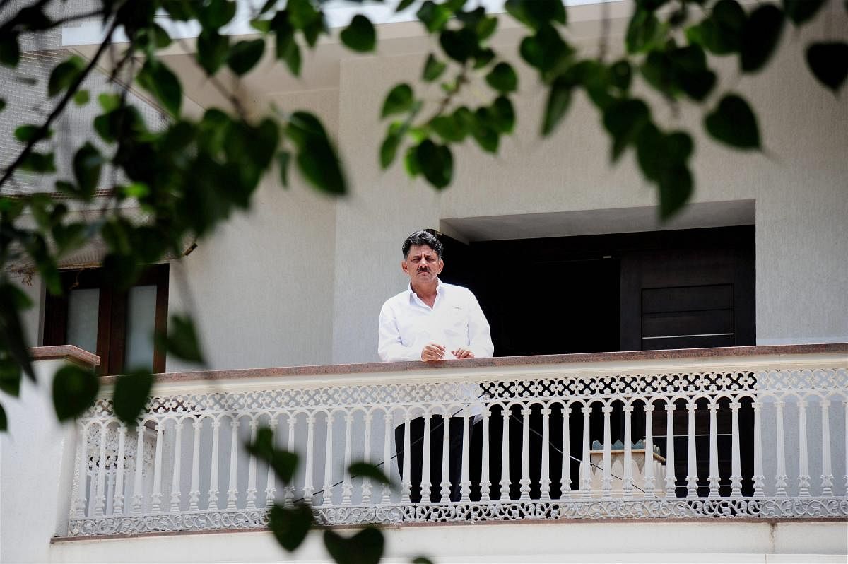 The then energy minister of Karnataka D K Shivakumar stands in the balcony of his residence in Bengaluru during an Income Tax raid in 2017. (PTI File Photo)