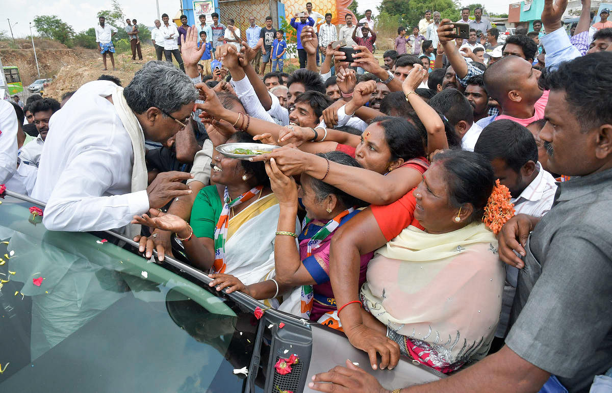 Chief Minister Siddaramiah along with others takes out a road show Chamundeshwari Assemble segment, in Mysuru on Monday. - PHOTO / DH PV PHOTOS