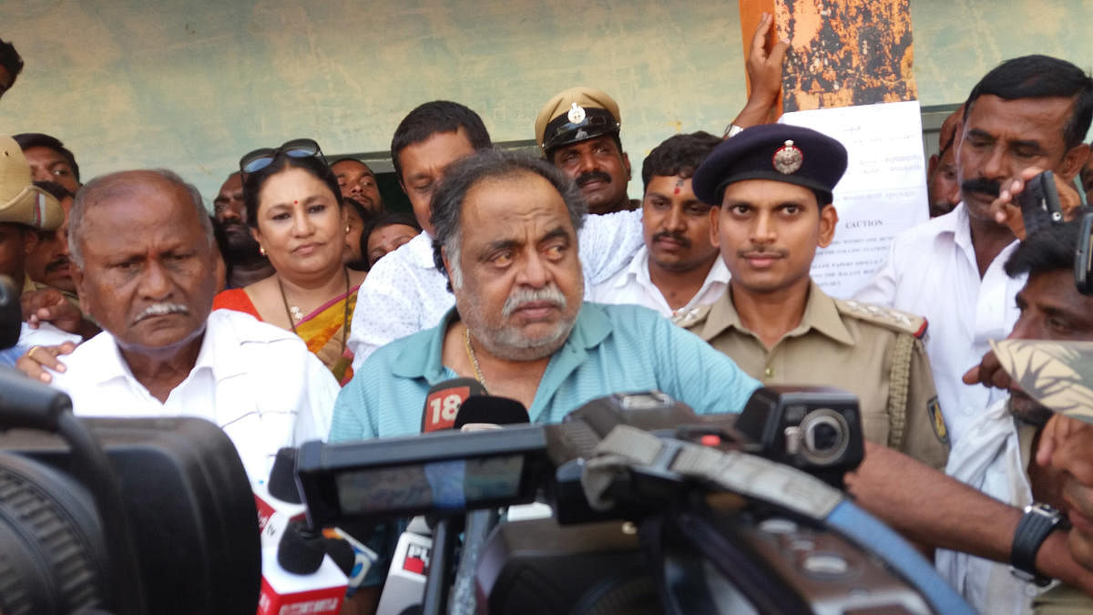 Former minister M H Ambareesh speaks to reporters after voting at Doddarasinakere village, near Bharathinagar, Mandya district, on Saturday.