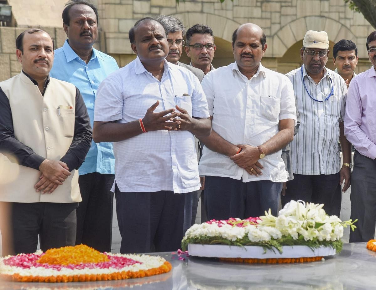 Karnataka Chief Minister H D Kumaraswamy pays tribute to Mahatma Gandhi at his memorial Rajghat, in New Delhi on Monday, May 28, 2018. PTI Photo