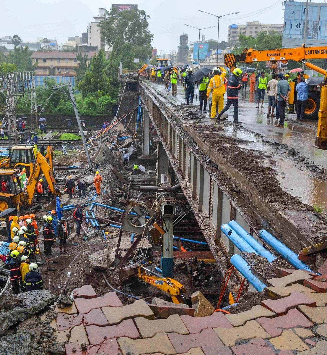 Rescue and relief work underway after a foot overbridge collapsed on the railway tracks following heavy rains, at Andheri Station in Mumbai. PTI photo