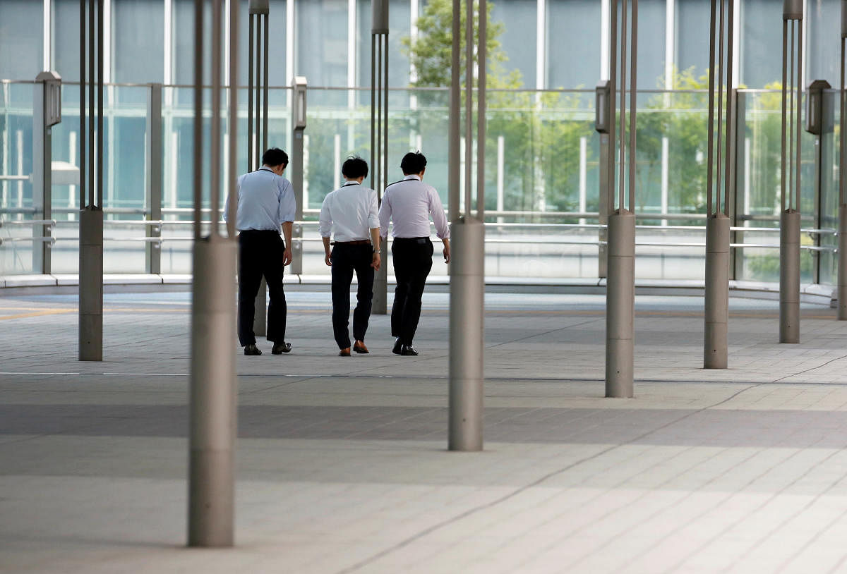 Businessmen walk during a heatwave in Tokyo, Japan. Reuters photo