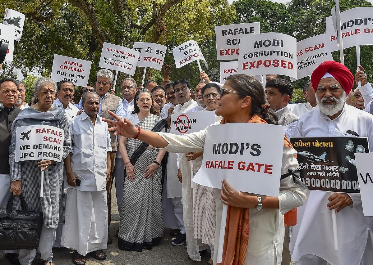 UPA chairperson Sonia Gandhi along with other Opposition party leaders raise slogans during a protest against the Union government over Rafale deal issue, at Parliament House in New Delhi on Friday. PTI