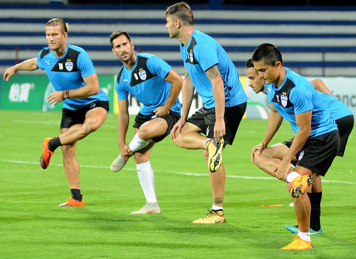 IN READINESS Bengaluru FC players warm-up ahead of a practice session on the eve of their AFC Cup clash against Altyn Asyr. DH Photo/ Srikanta Sharma R