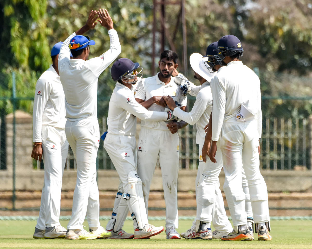 LEFT-ARM LETHAL: J Suchith (centre) celebrates with team-mates after taking a wicket. DH Photo/ Savitha B R