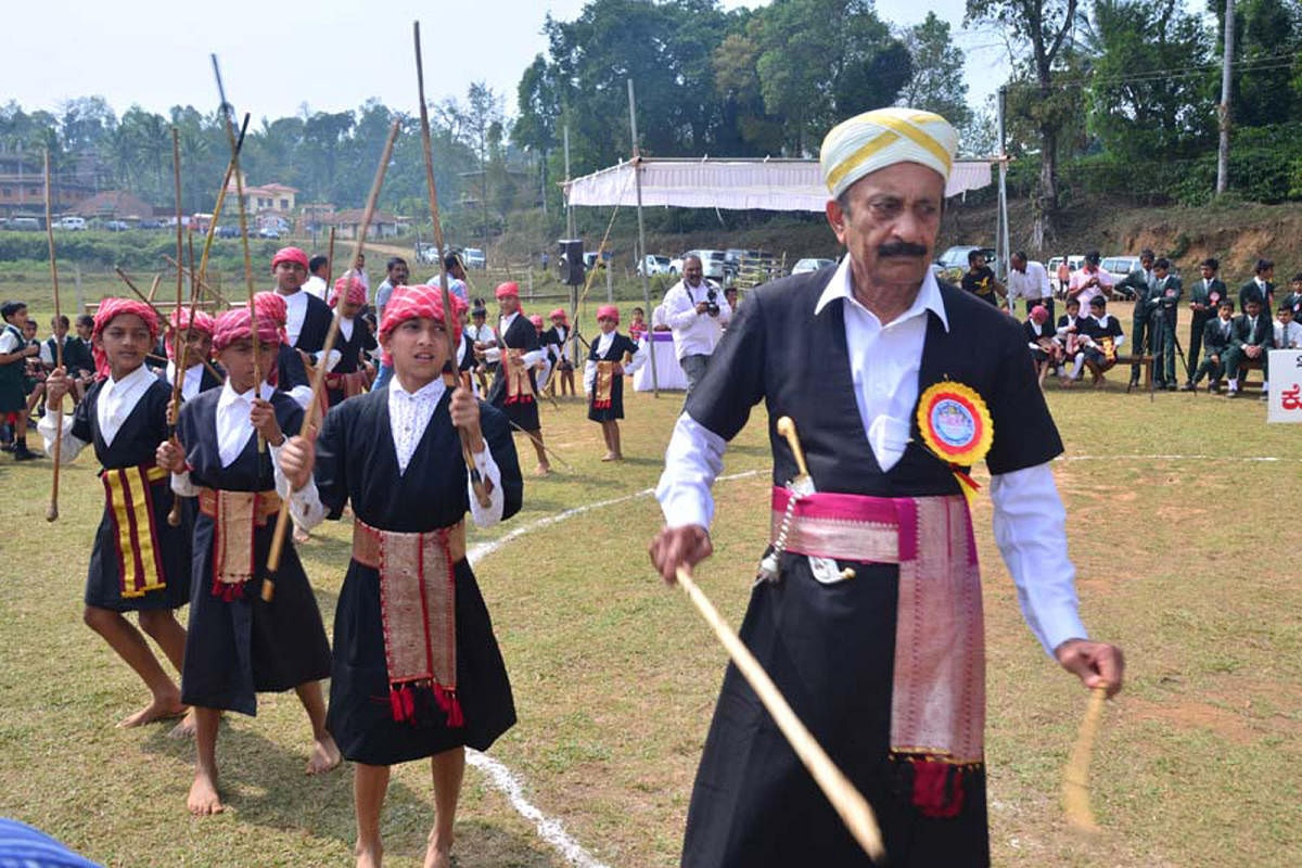 Former minister M C Nanaiah inaugurates the Kodava children's folk and cultural festival in Napoklu on Thursday, by dancing to the tune of Kodava traditional music.