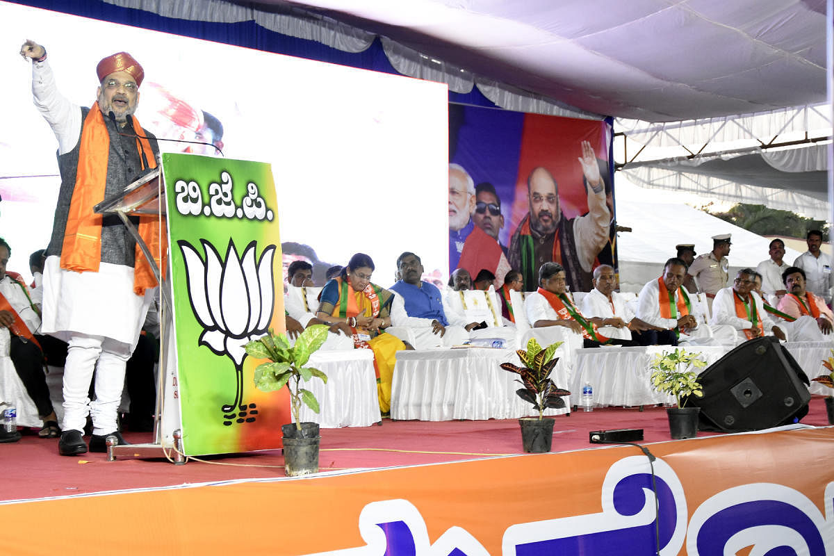 iN FULL FORCE: BJP president Amit Shah addresses a BJP rally in SINDHANUR on Thursday. Party general secretary Muralidhar Rao, former chief minister Jagadish Shettar, MP Sanganna Karadi and others are seen. dh photo