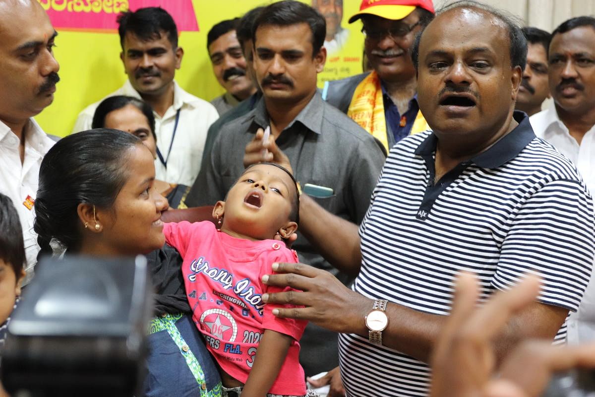 Chief Minister H.D. Kumaraswamy administer a polio vaccine to a child at his official residence, "Krishna" in Bengaluru. (DH Photo)
