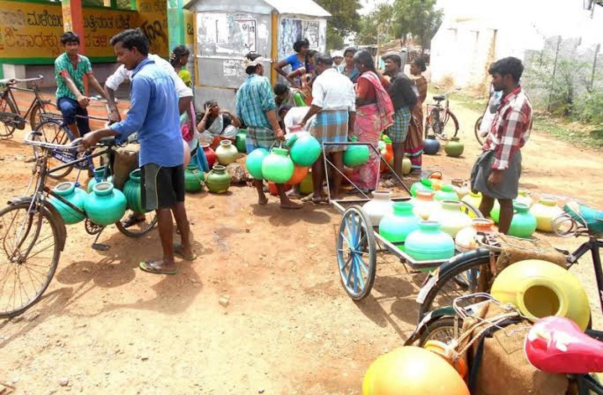 Aldoor residents collect water from a public tap.