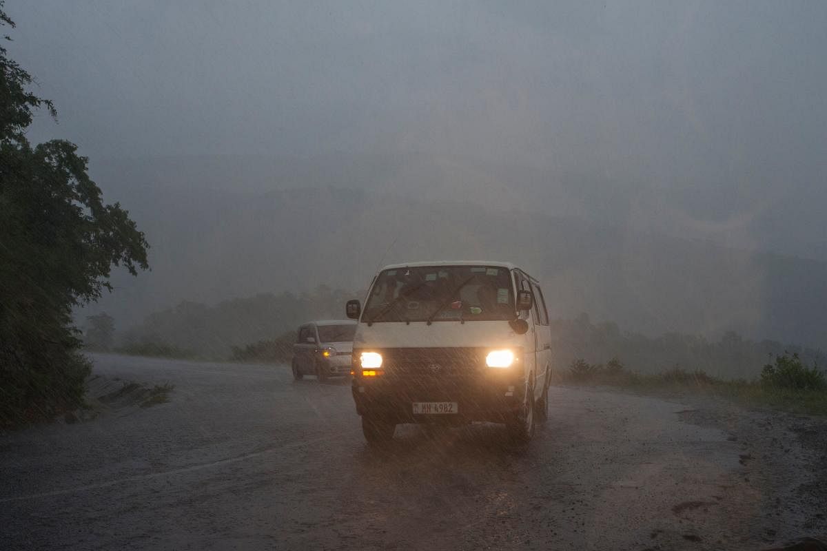 This picture taken on March 15, 2019 shows vehicles as rain, which is believed to be the beginning of Tropical cyclone Idai coming from central Mozambique, falls in the flooded districts of Chikwawaa and Nsanje in southern Malawi. AFP.