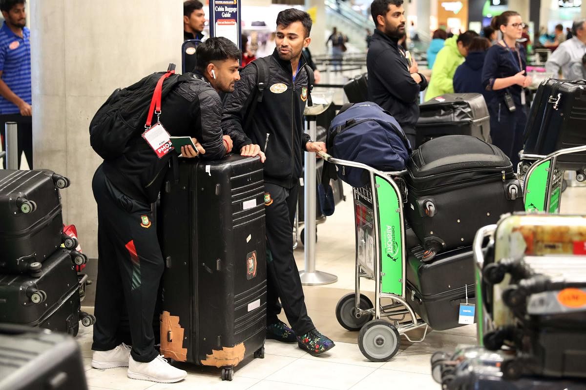 HOME BECKONS: Members of the Bangladesh cricket team check into Christchurch Airport on Friday. AFP