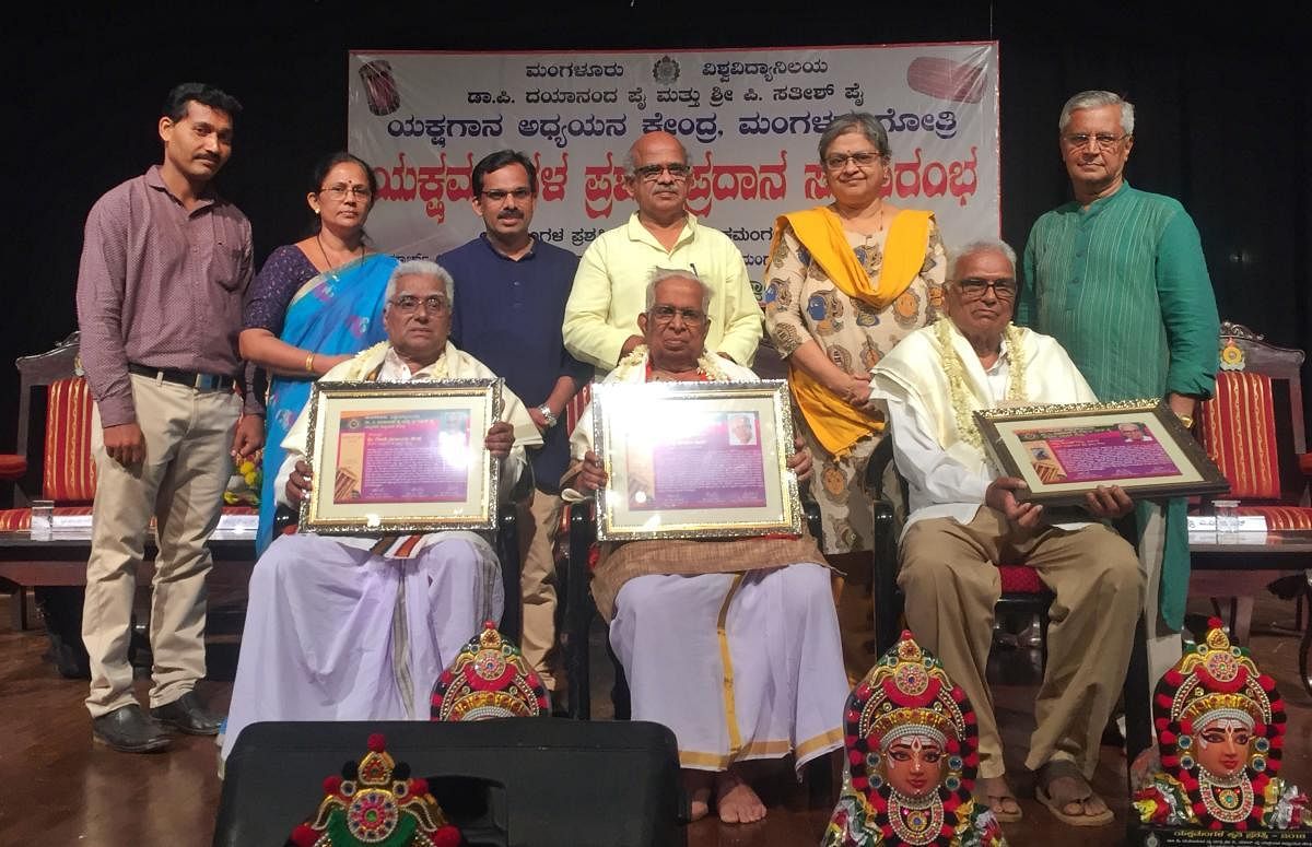 Yakshagana artistes Gode Narayana Hegde and Kumble Sundar Rao were handed the Yakshamangala awards while Prof G S Bhat Sagar receives the Yakshamangala Krithi award at a programme at Mangalore University.