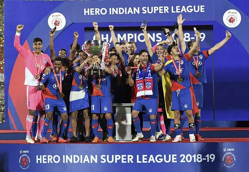 BLUES ARE THE BEST: Bengaluru FC players celebrate with the trophy after beating FC Goa FC in the ISL final in Mumbai on Sunday. BFC won 1-0 for the maiden title. PTI
