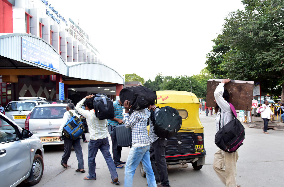 Passengers are seen at the KSR City Railway station, in Bengaluru. Photo/ B H Shivakumar