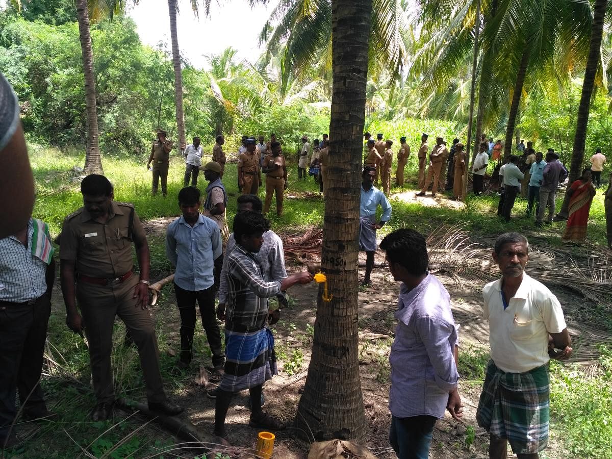 File photo of demarcation of boundaries for the Salem-Chennai Expressway being done in a farm land in Salem district, with police protection.