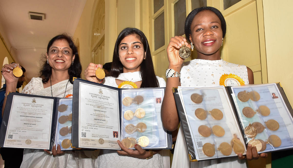 (From left) Meera Manohar Rao Anasane (10 Gold Medal), Sanjana Darala P (10 Gold Medal) and Emelife Stella Chinelo (20 Gold Medal) gold medal winners pose for a Photo during the 99th Annual Convocation of University of Mysore, organised at Crawford Hall i