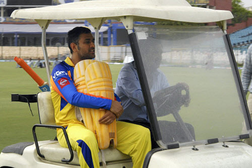 Chennai Super Kings Captain M S Dhoni leaving the ground in a battery car after a sudden rain disrupted a practice session in Jaipur on Monday. PTI Photo