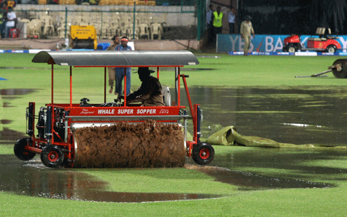 A Super sopper machine on the ground as it rains before start of the match between RCB and Chennai Supar Kings at Chinnaswamy stadium in Bengaluru on Saturday. PTI Photo