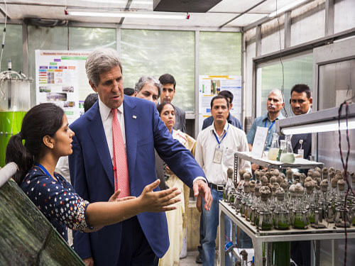 global attention U.S. Secretary of State John Kerry speaks with graduate student, Poonam Choudhary, about her work studying algae at the Indian Institute of Technology, Delhi on Thursday. The visit by Kerry to India is his first following the resounding election win of Prime Minister Narendra Modi in May.  AP photo