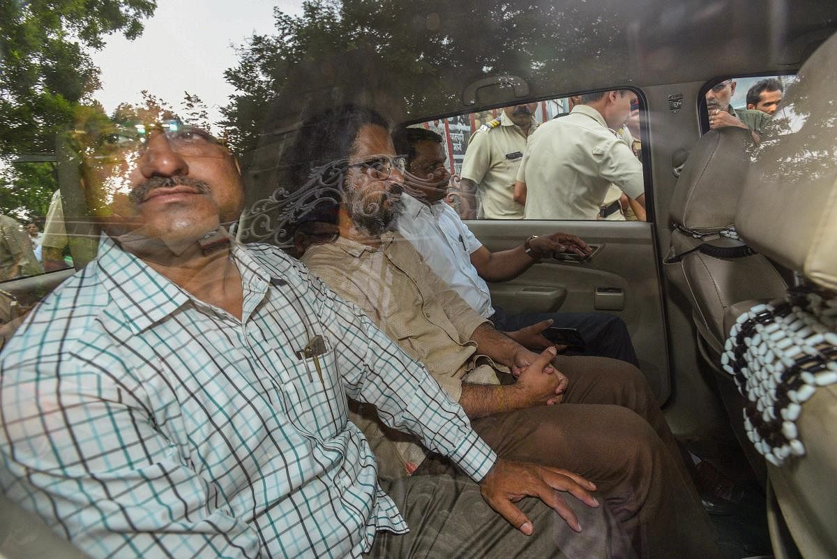 One of the accused arrested by Pune Police in the alleged Maoist links in the Bheema-Koregaon violence case, being taken to the court, in Pune on Thursday. PTI Photo