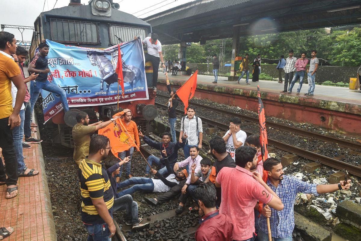 Maratha Kranti Morcha protesters stop a train during their statewide bandh, called for reservations in jobs and education, at Thane in Mumbai on Wednesday, July 25, 2018. (PTI Photo)