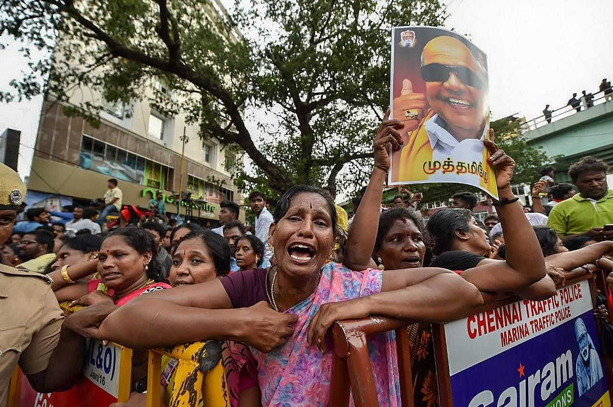 DMK supporters react after the party president M Karunanidhi passed away, in Chennai on Tuesday (PTI Photo/R Senthil Kumar)
