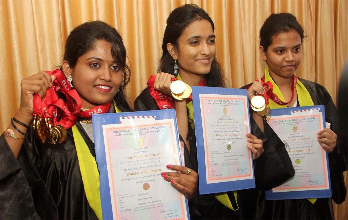 (From left) N Suchitra (nine gold medals), Meghana Prakash and Madhushri (six golds each) proudly display their medals and merit certificates at the 18th convocation of Visvesvaraya Technological University in Belagavi on Monday. DH PHOTO