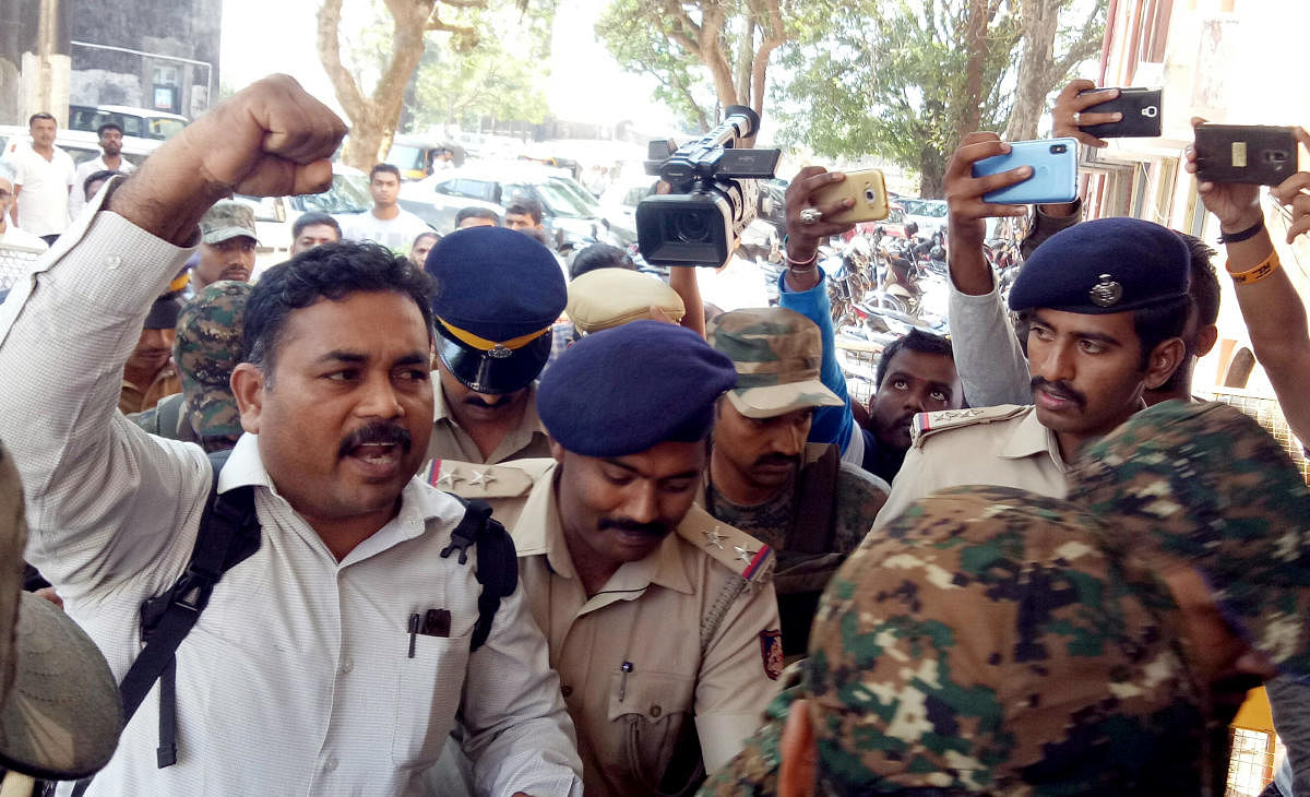 Roopesh being brought to the District Principal and Sessions Court in Madikeri on Tuesday.