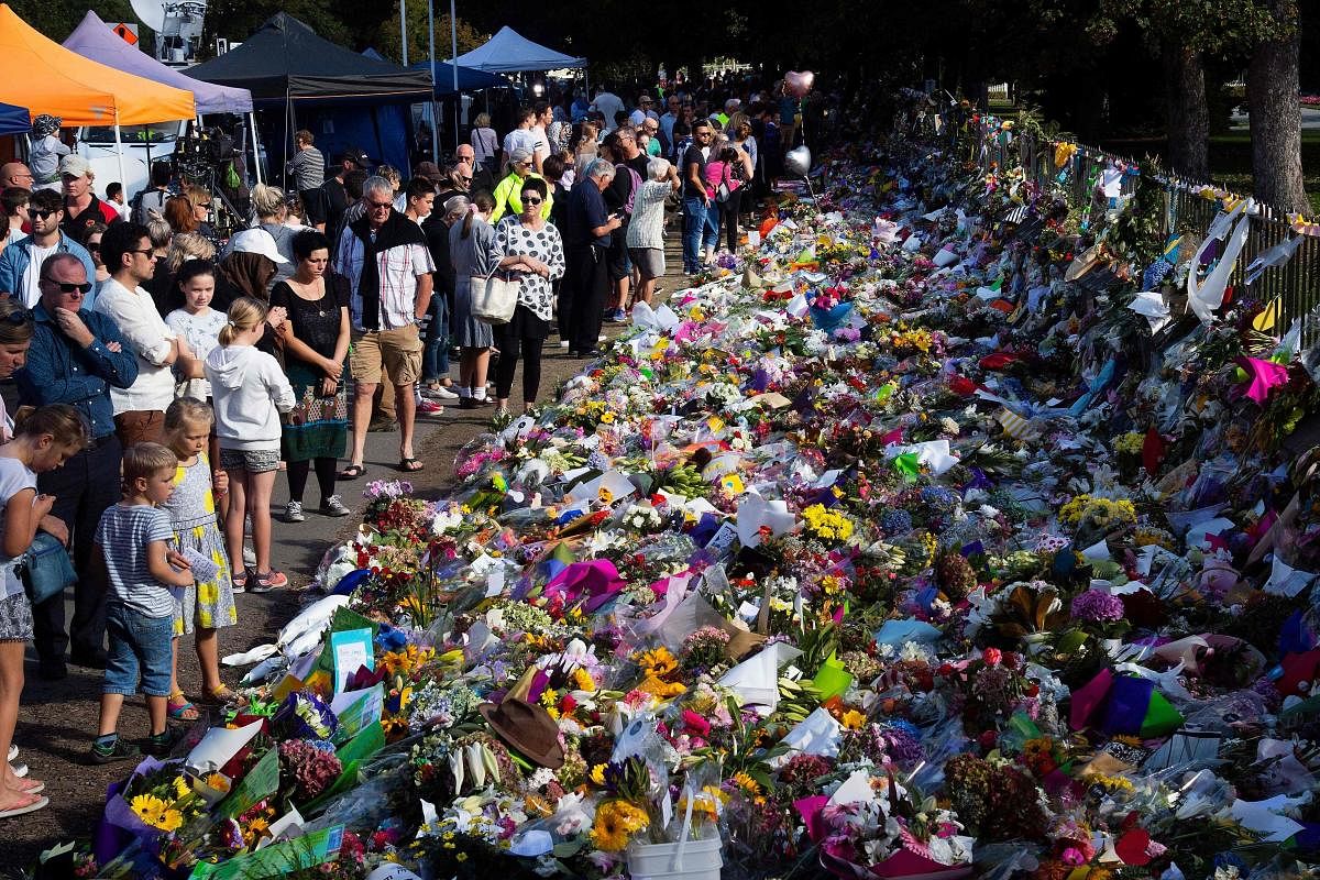 People pay tributes to those gunned down in Christchurch, NZ, on March 15.