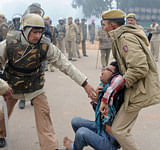 Indian demonstrators are arrested by police during a protest calling for better safety for women following the rape of a student last week, in front the India Gate monument in New Delhi on December 23, 2012. In the biggest protest so far, several thousand college students rallied at the India Gate monument in the heart of the capital where they were baton-charged, water cannoned and tear gassed by the police. AFP PHOTO