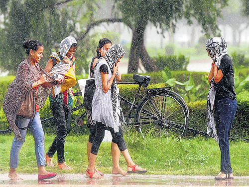 Girls enjoy dip in temperature at Rajpath after rains lashed New Delhi on Thursday. PTI