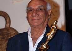 Indian Bollywood producer and director Yash Chopra holds his trophy during the V Shantaram Awards 2009 ceremony in Mumbai on Monday. AFP
