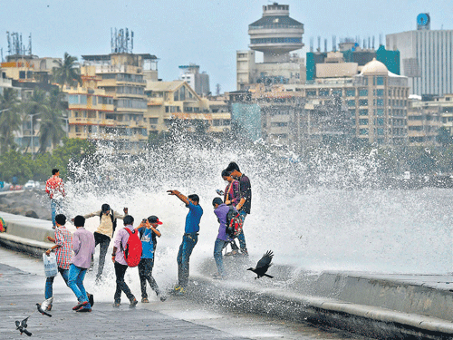 sea spray: People enjoy high tide during a monsoon season in Mumbai on Sunday.  pti photo