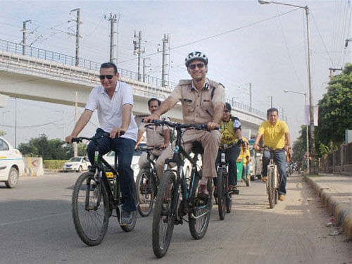 Gurgaon police commissioner Navdeep Singh Virk and other officials ride cycle to observe car-free day in Gurgaon. PTI photo