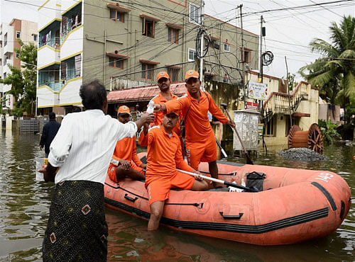 National Disaster Response Force (NDRF) team carrying out relief works in Velachery, one of the worst flood-hit areas in Chennai on Saturday. PTI Photo