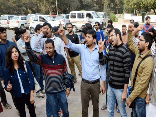 Students affiliated to the Akhil Bharatiya Vidyarthi Parishad (ABVP) protest outside the office of the vice chancellor of Jawaharlal Nehru University (JNU) in New Delhi on Wednesday to vent their ire over a programme describing the execution of 2001 Parliament attack convict Afzal Guru as 'judicial killing'. PTI Photo.