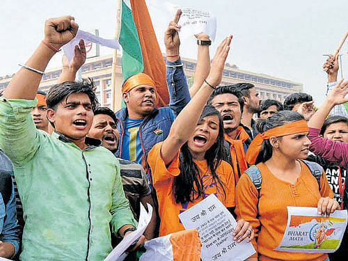 ABVP activists protest against an event at JNU supporting Parliament attack convict Afzal Guru in New Delhi on Friday. PTI