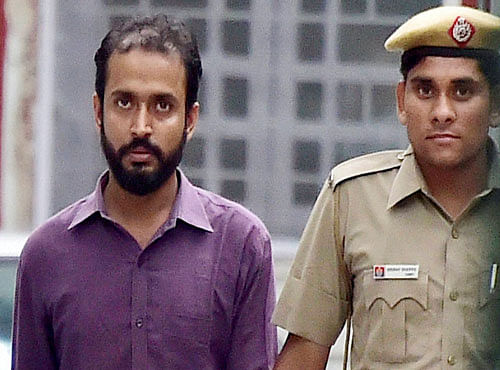 Anmol Ratan, 29, a Ph D student of Jawaharlal Nehru University, accused of rape by a fellow student, being produced at Patiala house court in New Delhi on Thursday after his surrender to police last night. PTI Photo