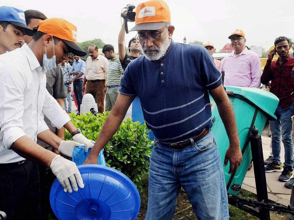 Minister of State for Tourism (I/C) and Electronics & Information Technology, Alphons Kannanthanam participating in a cleanliness drive as part of 'Swachhta Hi Sewa' campaign, organised by Ministry of Tourism, in New Delhi on Sunday. PTI