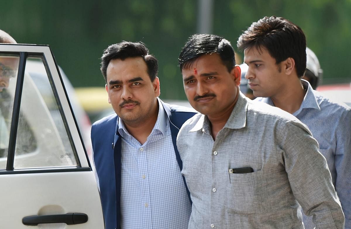 Delhi-based journalist Upendra Rai (L) being produced in a CBI court in New Delhi on Friday. Rai has been arrested for allegedly indulging in dubious financial transactions and getting an airport access pass made by the Bureau of Civil Aviation Security (