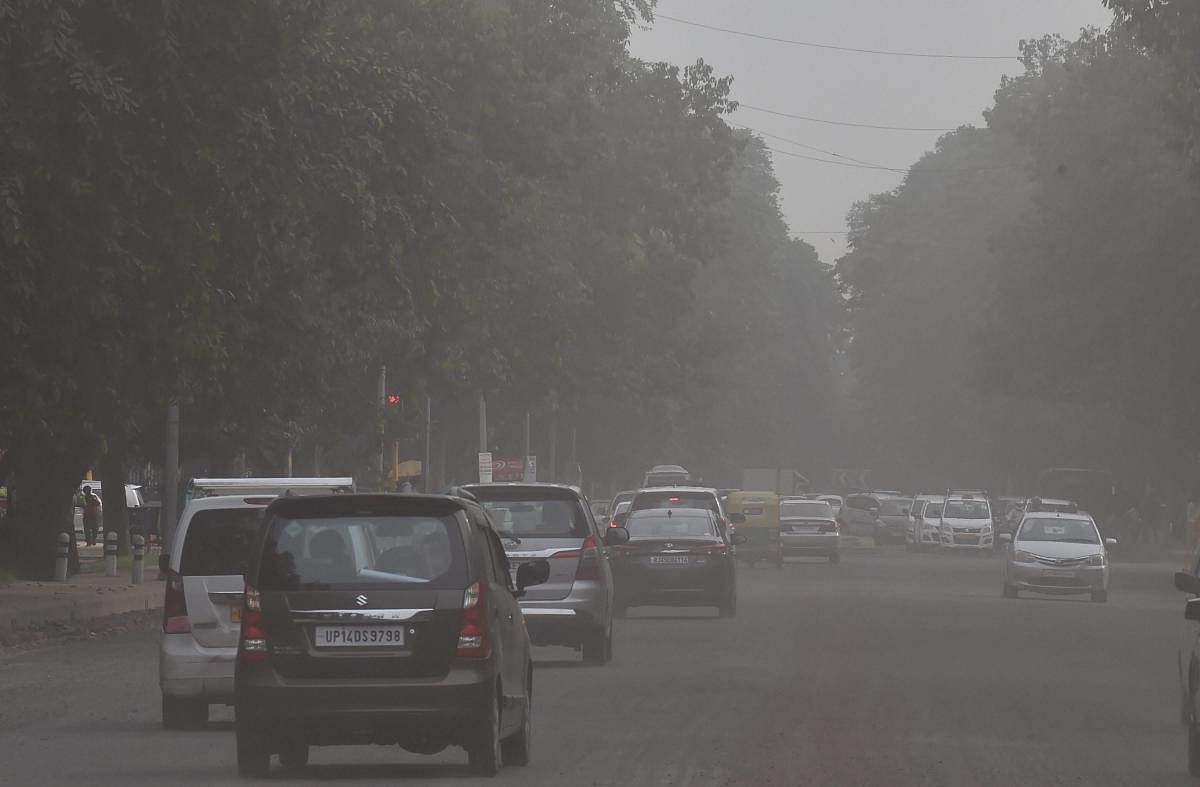 Vehicles plying at Janpath Road, in New Delhi, on Tuesday. (PTI Photo)